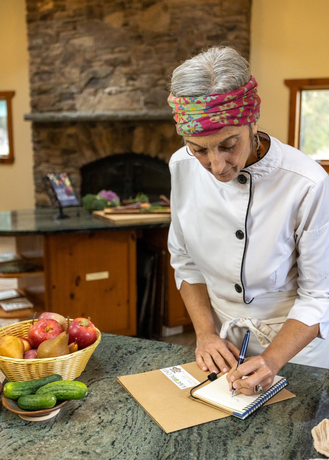 Cathy Vogt working on a recipe in a kitchen with a variety of fresh ingredients